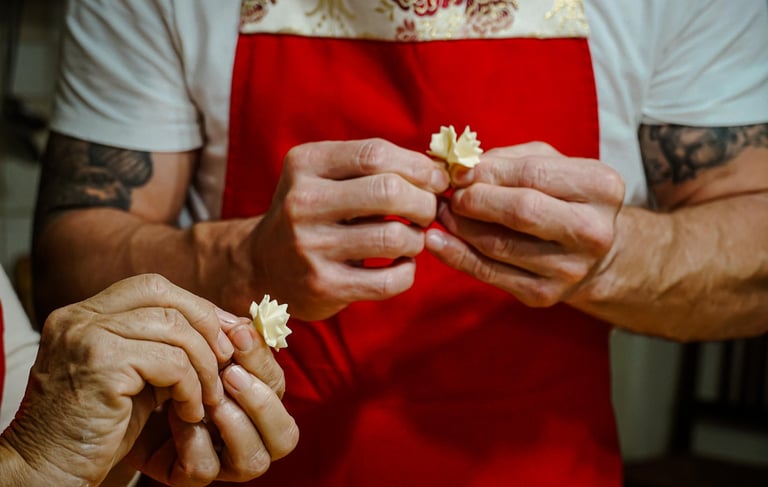Hands shaping traditional Sardinian pasta during a cooking class.