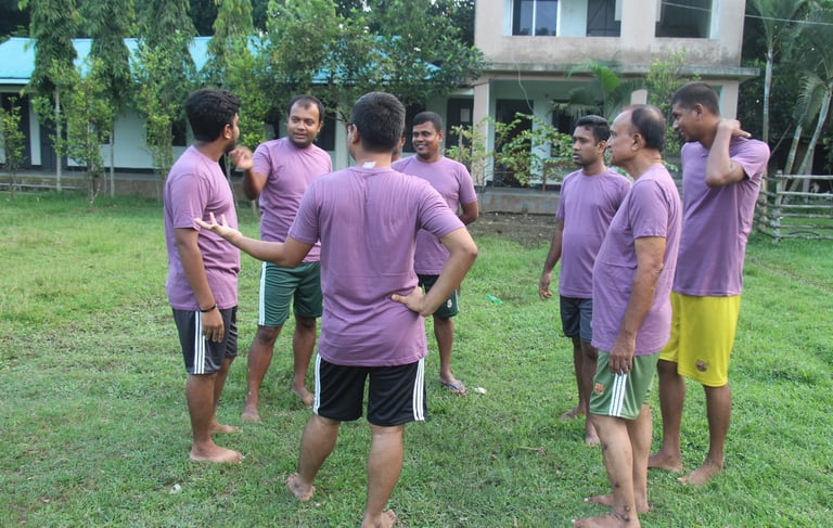 a group of men standing around a soccer ball