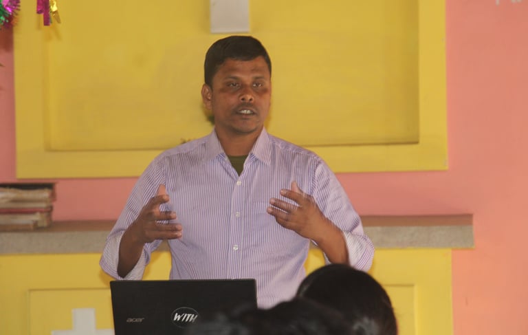 a man standing in front of a laptop computer