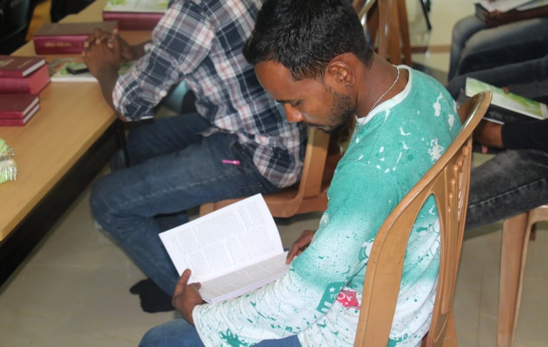 a man sitting in a chair with a book