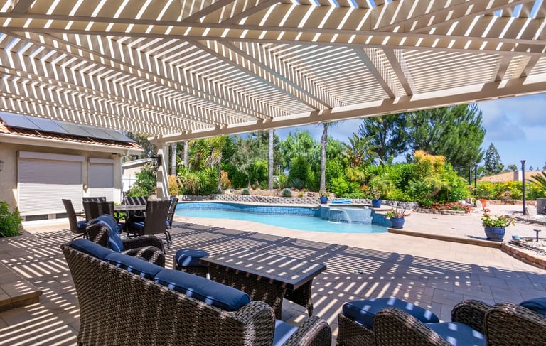 Large Alumawood lattice shade structure with double beam and rafters and mitered corner, poolside.