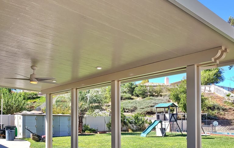 Insulated Alumawood patio cover with playground set in background