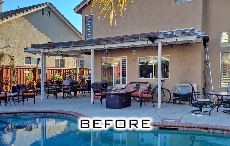 Two story home with old white lattice structure next to pool,