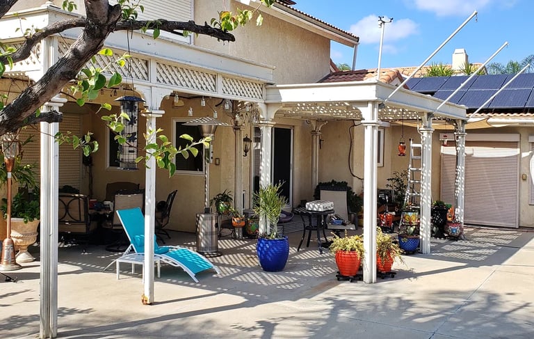 Ornate style wood pergola over a patio.