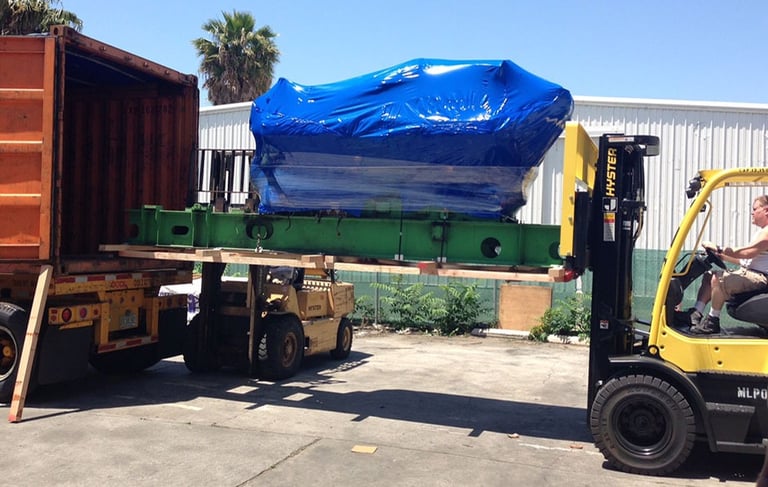 a large product with blue covered being loaded into a truck