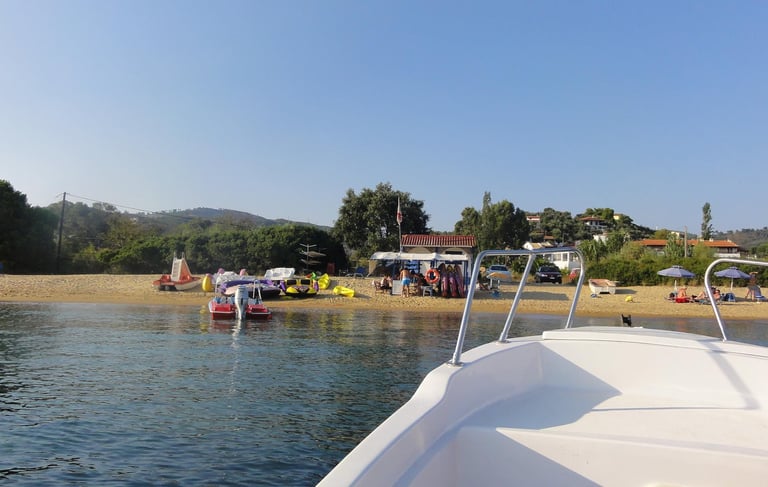 a boat on the water with people on the beach