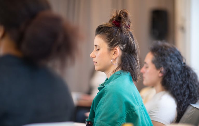 Woman with eyes closed practicing a breathing exercise to prepare for public speaking.