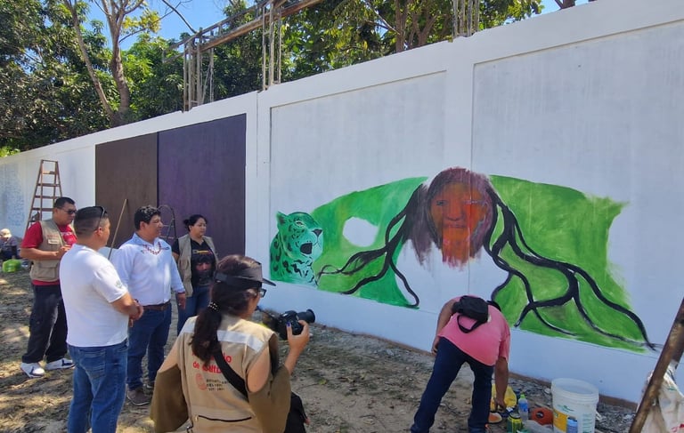 Ministery of Culture gathering during a colorful street art mural of a jaguar and figure is painted.