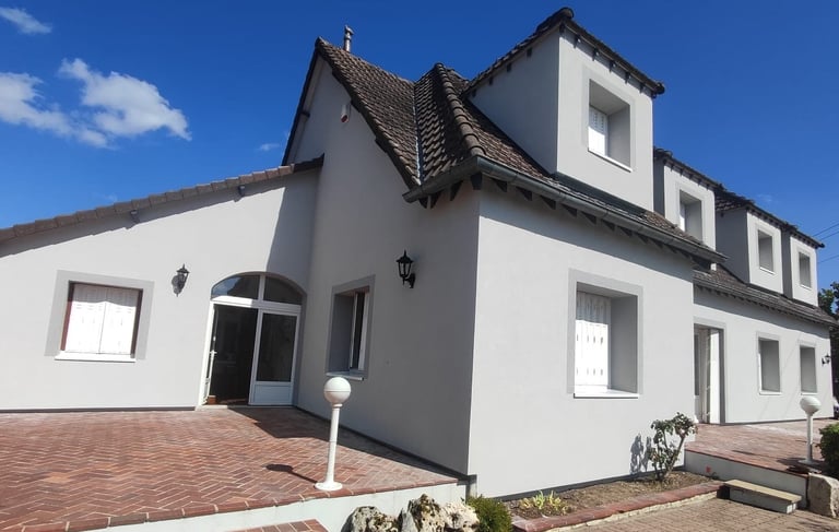 a house with a brick wall and a brick wall