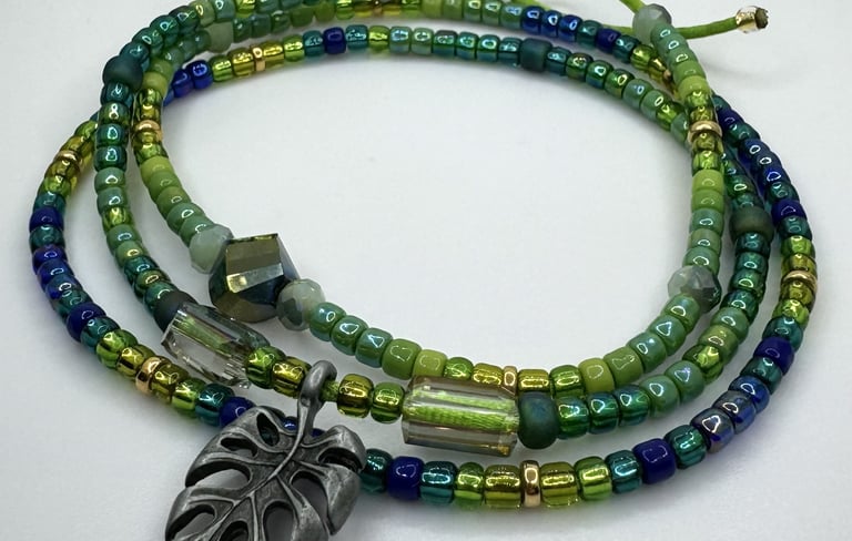 Tiny iridescent glass beads in vibrant shades of green blue & gold in a triple wrap bracelet design