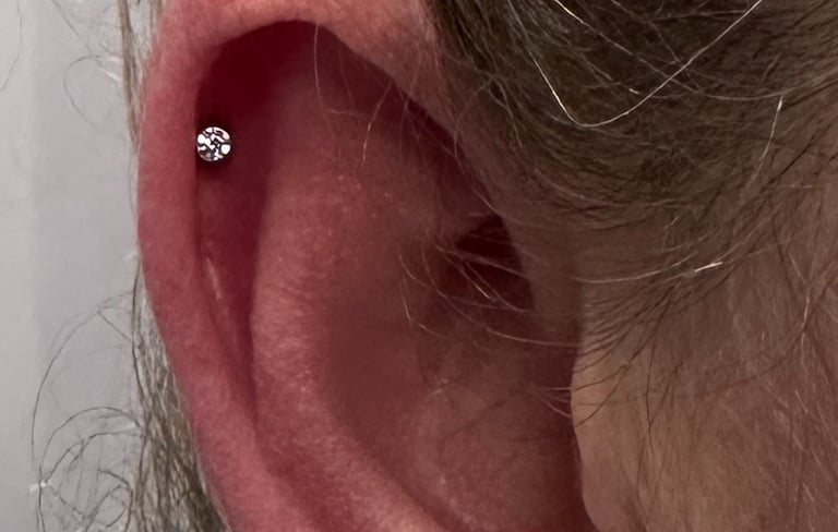 Licensed helix piercing with titanium jewellery in Stonehaven studio