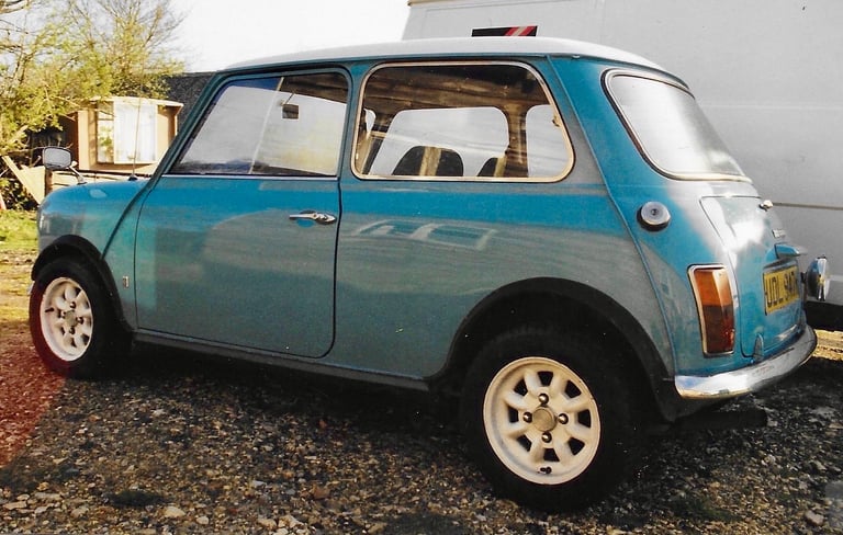 a classic mark one surf blue Austin mini with a white roof