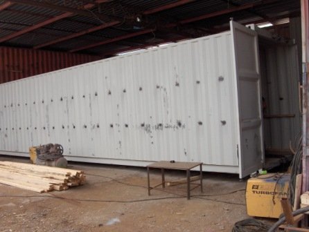 a container container house with a large container in the middle of it