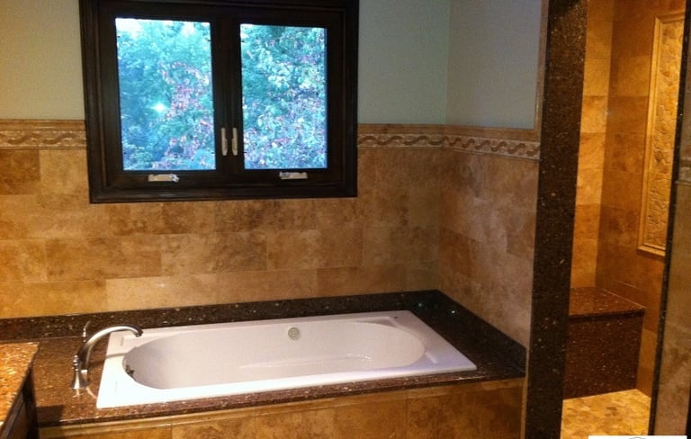 After tile installation, custom build shower, lighting update. Bathroom remodeled in Mount Prospect