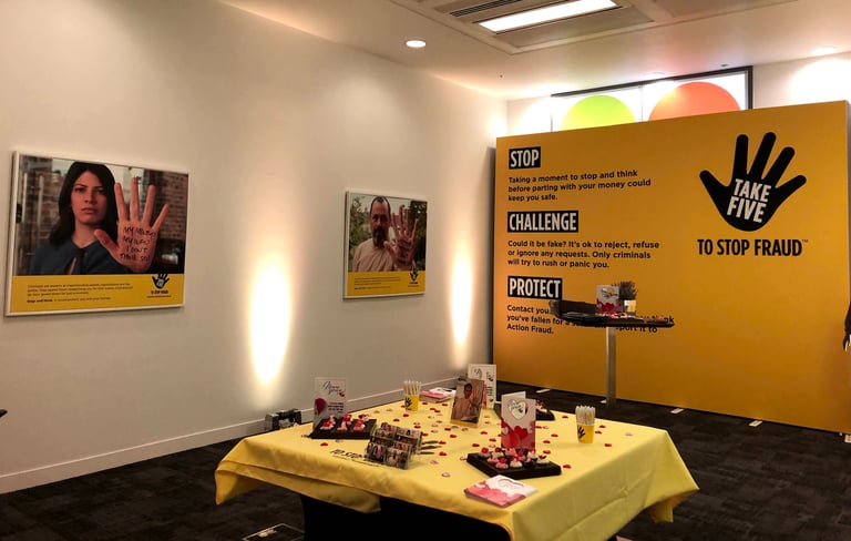 a room with a large banner, posters and a table 