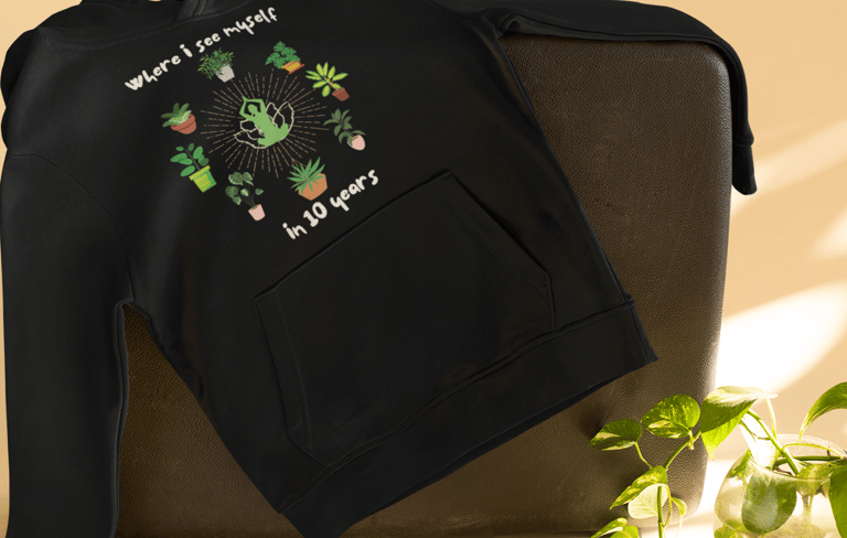 Cozy black hoodie with playful plant illustration — plant-lover sweatshirt from Miss Chatty Plants.