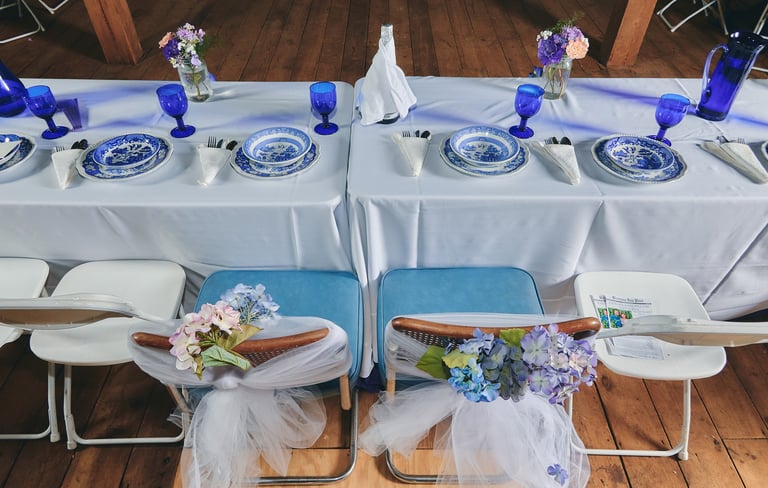 a table with a plate set and flower for a wedding