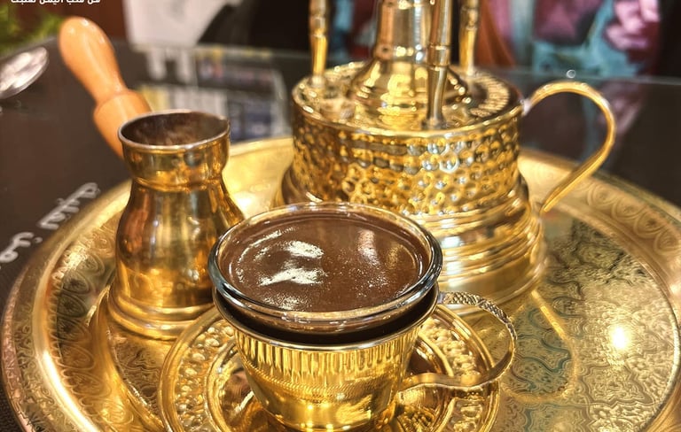 a gold plated tray with a cup of coffee and a cup of coffee