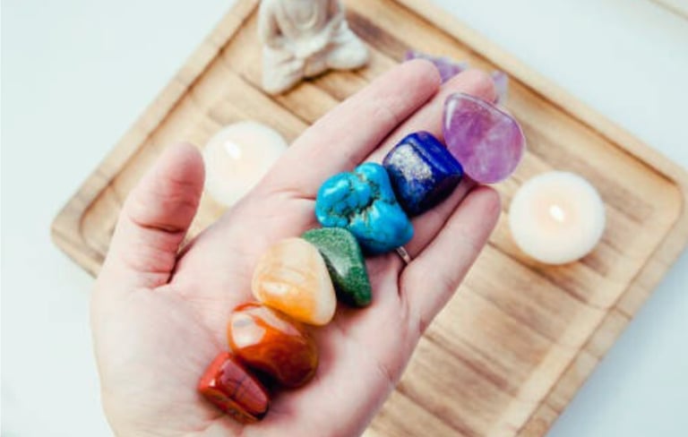 Hand holding chakra stones  a lotus representing spiritual alignment & inner peace.