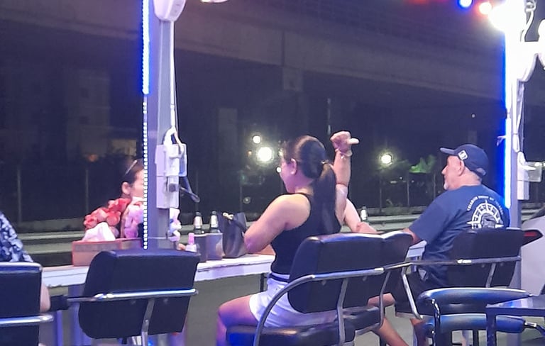 Thai women and customer sat in bar near Soi 94 in Hua Hin