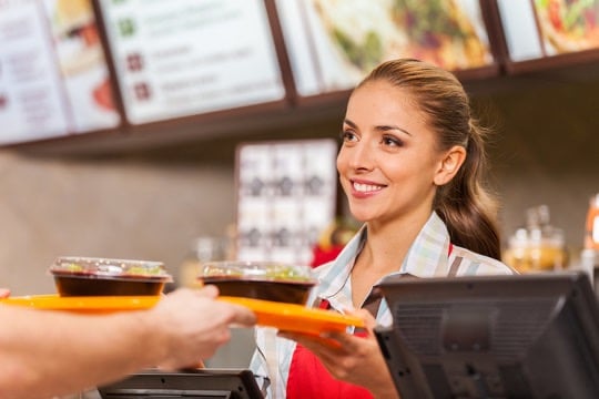 a waitress at a restaurant with a customer
