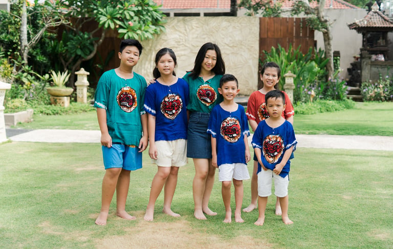Extended family session at Lumbini Villas Jimbaran showing parents and children standing together in a relaxed outdoor 