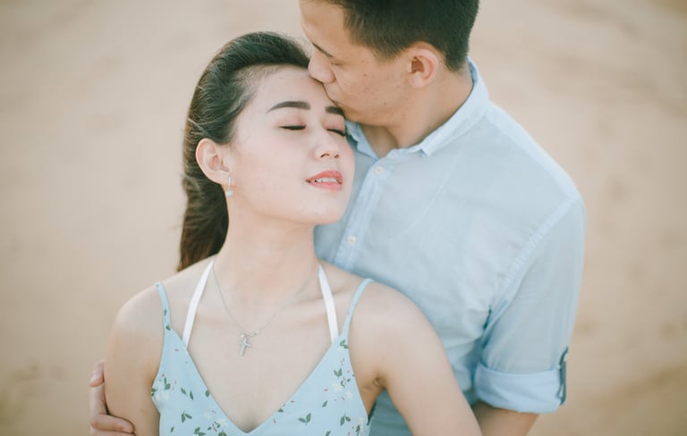 Close intimate couple portrait on beach at Sofitel Bali Nusa Dua Beach Resort.