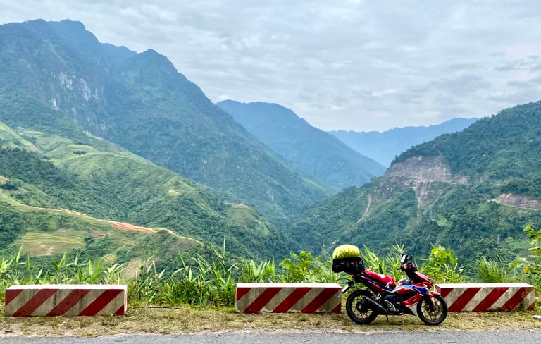 a motorcycle parked on a mountain side road