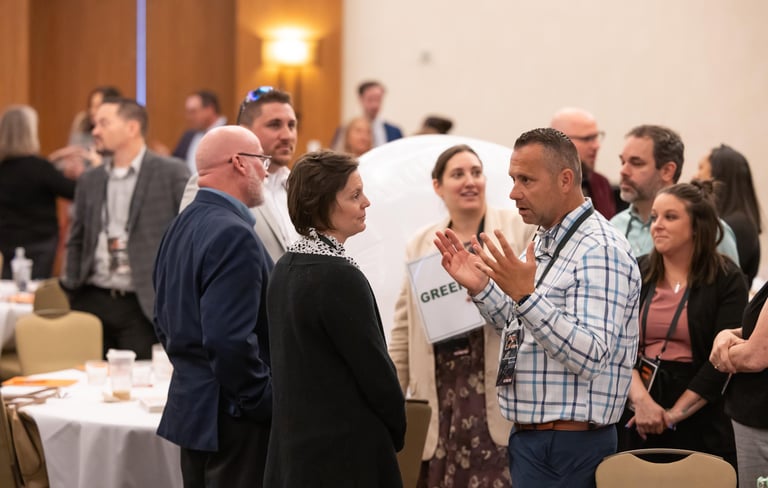 Attendees networking at Unleashing Radiance leadership event.