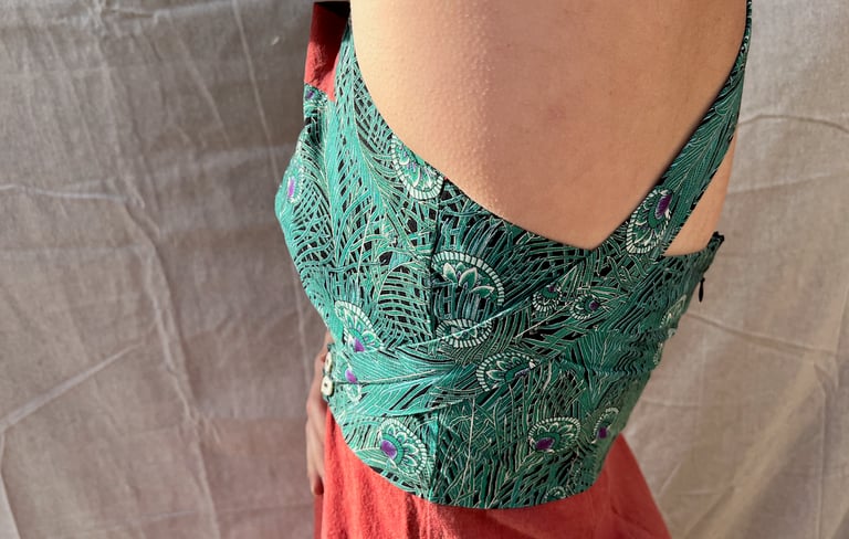Side view of the bodice of a green and amber maxi dress
