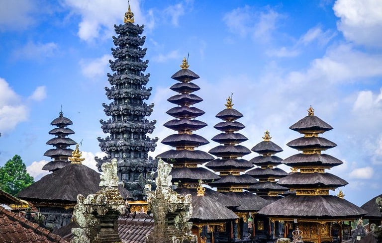 Besakih Temple gates made of black volcanic stone against a clear blue sky