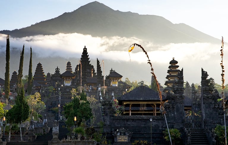 Besakih Temple gates made of black volcanic stone against a clear blue sky