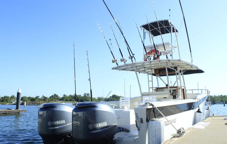 a boat docked at a dock with fishing rods