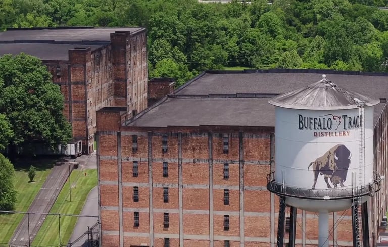 a large building with a water tower in the middle of it Buffalo Trace Distillery