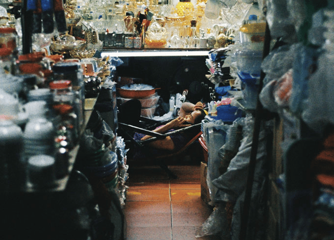 Market vendor relaxing in Saigon