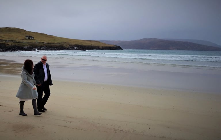 a wedding couple walking on a beach