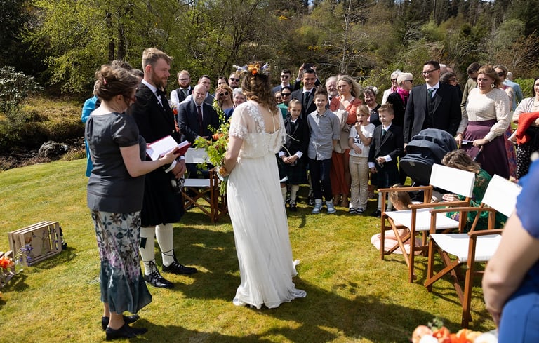 a bride and groom are standing in front of a crowd of people