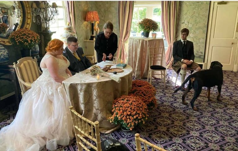 a bride and groom are sitting at a table