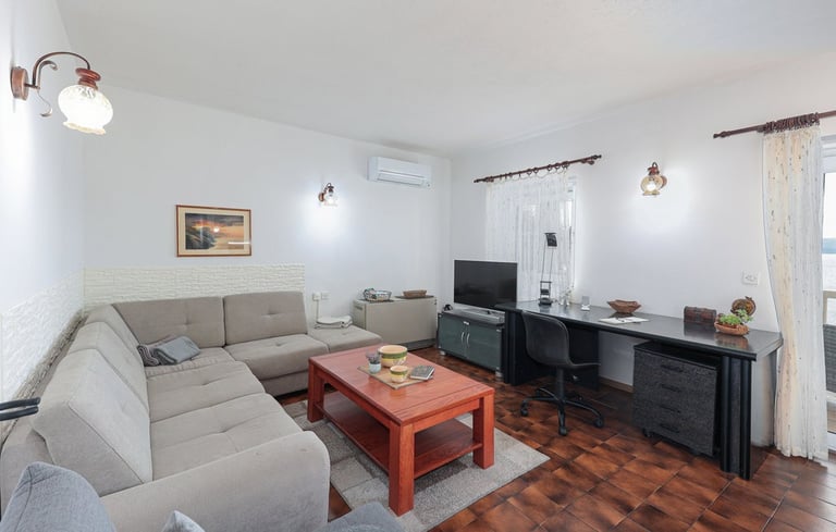 The photo shows the apartment's spacious living room. 