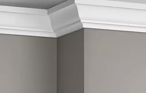 crown molding painted white installed in a room with grey paint on the walls.