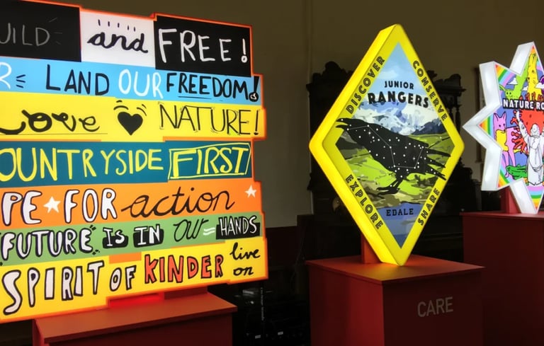 Lightboxes with bright colours, words of protest and nature images