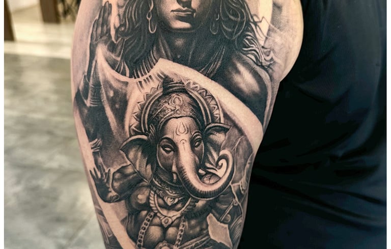 Photo of a religious shiva and ganesha tattoo on the bicep