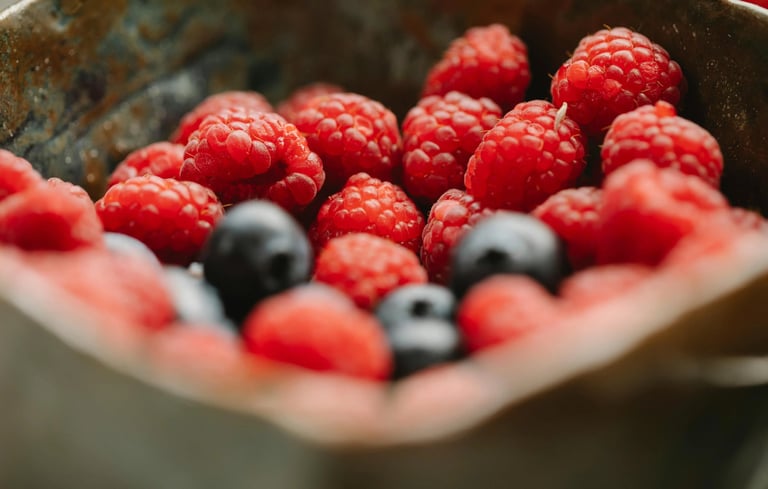 a bowl of raspberries and berries in a bowl
