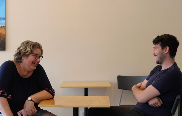 a man and woman sitting at a table at capital city mission
