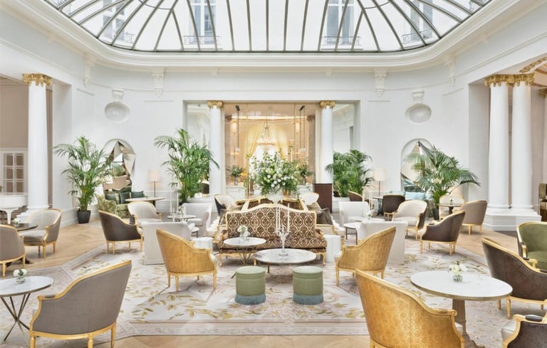 Palm Court Restaurant – A sophisticated dining area under a stunning glass ceiling with lush greener