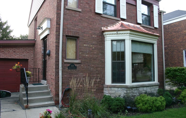 Custom made poplar trim and a new copper "roof" on the big bay window. Restoration nearly complete.