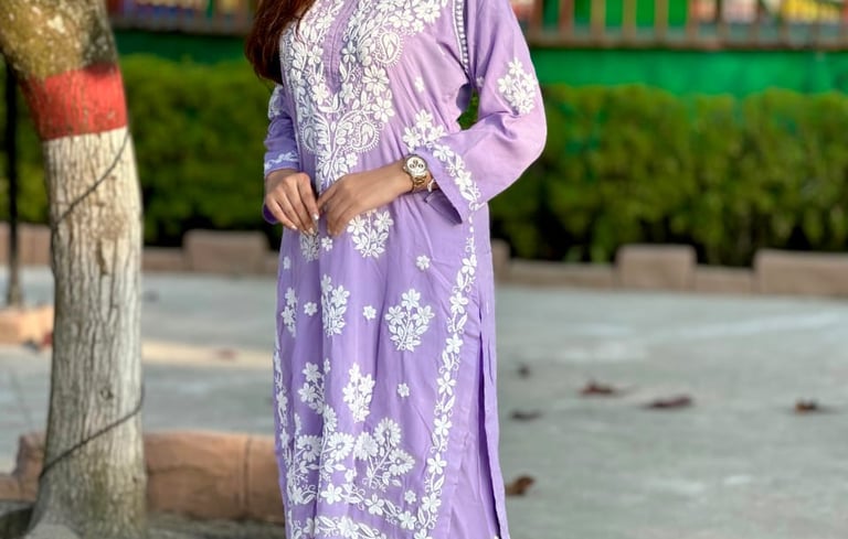 a woman in a purple dress with a white shirt and gold sandals