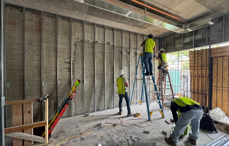 Light-gauge steel stud framing installation in a Washington DC commercial building interior