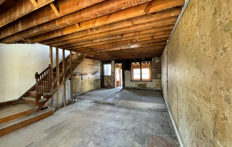a room with a staircase and stairs leading up to a staircase