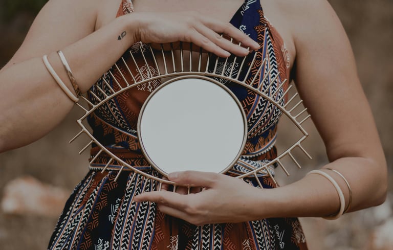 a woman holding a mirror in her hands